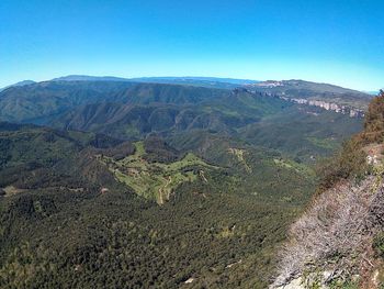 Scenic view of mountains against clear blue sky