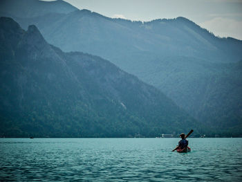 Scenic view of river and mountains against sky