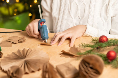 Midsection of woman holding christmas tree