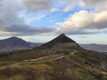 Scenic view of mountains against cloudy sky