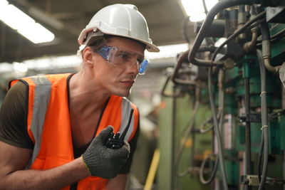 Side view of man working in factory