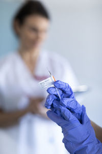 Nurse holding syringe with covid-19 vaccine