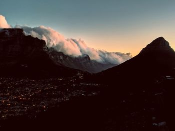 Scenic view of snowcapped mountains against sky during sunset