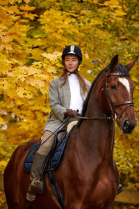 Young woman riding horse