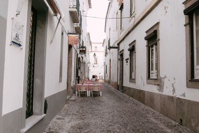 Rear view of people on street amidst buildings