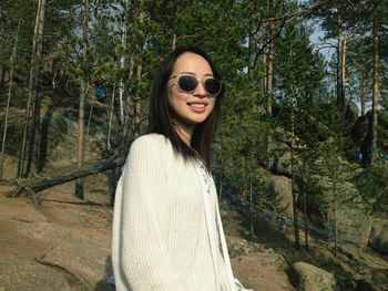 Portrait of smiling young woman in forest