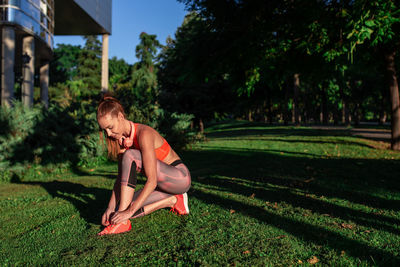 Rear view of shirtless boy on grassy field