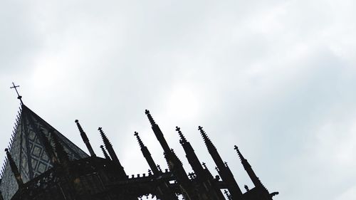 Low angle view of modern building against cloudy sky