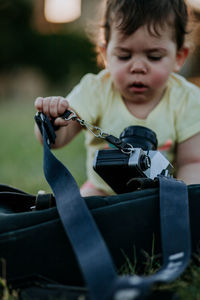 Close-up of baby holding camera