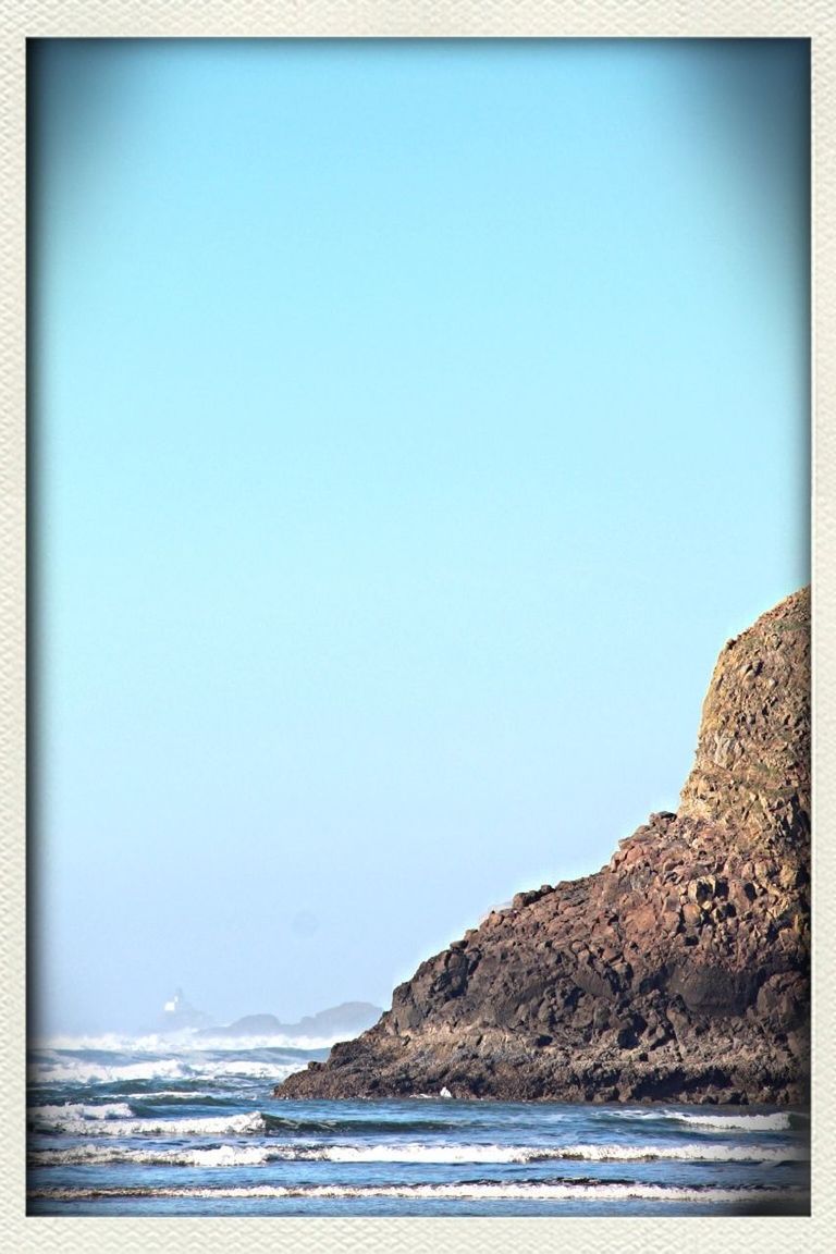 sea, clear sky, water, copy space, scenics, tranquil scene, tranquility, beauty in nature, blue, horizon over water, nature, beach, mountain, transfer print, idyllic, auto post production filter, shore, waterfront, rock formation, coastline