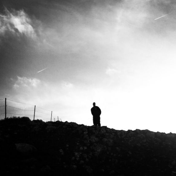 sky, standing, silhouette, rear view, lifestyles, full length, tranquility, men, leisure activity, tranquil scene, cloud - sky, nature, landscape, low angle view, cloud, solitude, beauty in nature, scenics