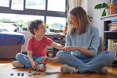 Loving moment of happy mother playing with her children.