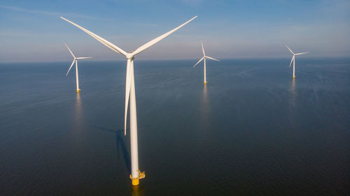 Low angle view of windmill against sky