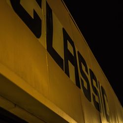 Low angle view of information sign at night