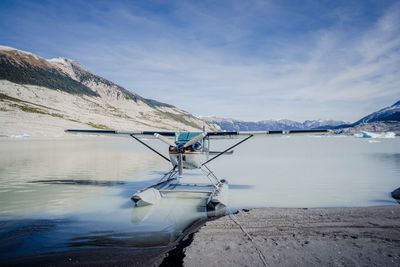 Scenic view of snowcapped mountains by lake against sky