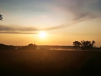 Scenic view of silhouette landscape against sky at sunset