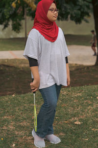 Low section of woman standing on field