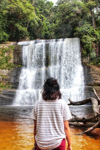 Beautiful waterfalls and girl in the borneo forest