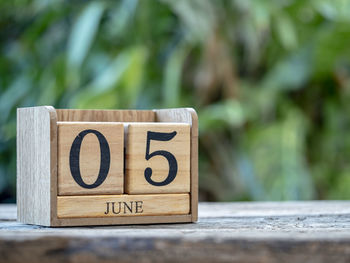 Close-up of text on wooden table