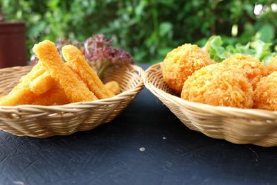 Close-up of snacks in wicker baskets on table