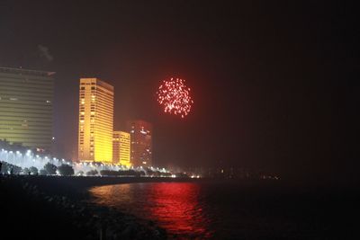 Firework display in city at night