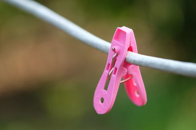 Close-up of clothespins hanging on clothesline