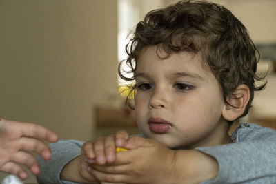 Close-up portrait of cute boy at home