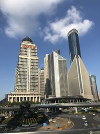 Low angle view of buildings against cloudy sky