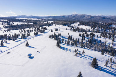 Aerial drone view of snow covered winter landscape in the mountains