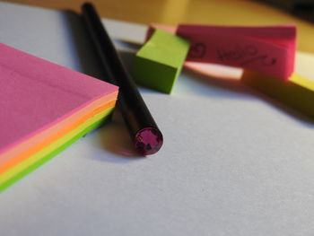 High angle view of pencil by sticky notes on table