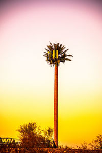 Silhouette palm tree against orange sky
