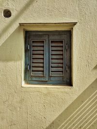 Low angle view of window on wall of building