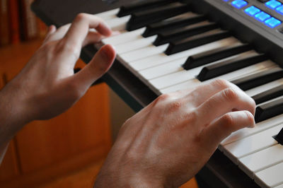 Close up of blind man hands playing the piano