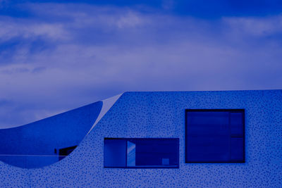 Low angle view of building against blue sky