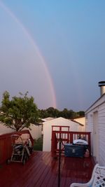 Rainbow over houses against clear sky