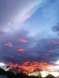 Low angle view of silhouette trees against sky at sunset