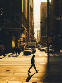 People walking on street amidst buildings in city