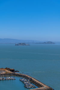 High angle view of sea against clear blue sky