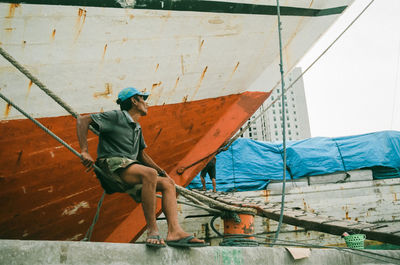 Low angle view of man standing on pier