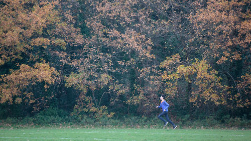 Side view of man standing on golf course