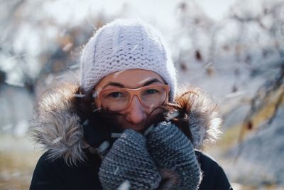 Portrait of woman wearing warm clothing during snowfall