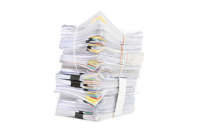 Close-up of paper stack against white background