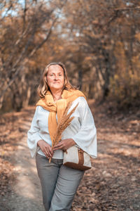 Portrait of smiling young woman during autumn