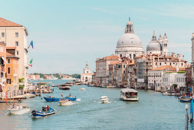 Boats in city against sky