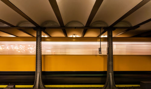 Train at illuminated railroad station