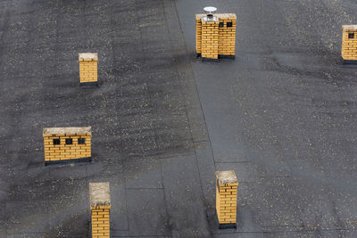 High angle view of road sign by buildings in city