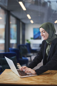 Woman in office using laptop