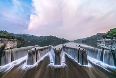 Dam and lake against sky