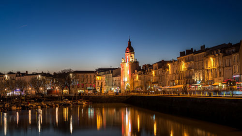 Panoramic view of the grosse horloge of la rochelle at blue hour with illuminated city light