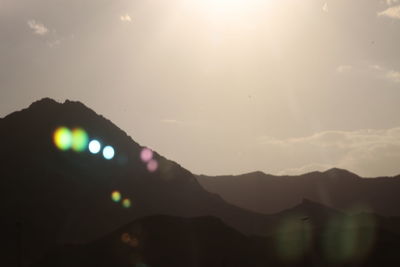 Scenic view of silhouette mountains against sky during sunset